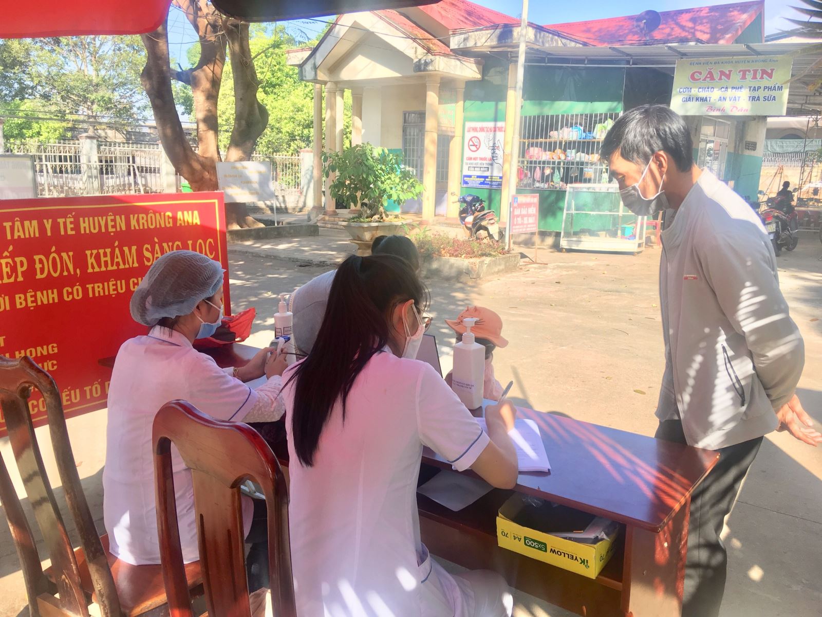  nhân viên y tế hướng dẫn khai báo y tế cho người đến khám chữa bệnh tại TTYT Krông Ana